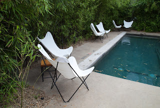 Fine art image of lawn chairs next to a swimming pool, taken in Austin, Texas on South Congress Avenue