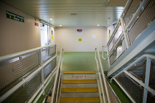 Interior view of stairs and railing taken inside a ferry boat.