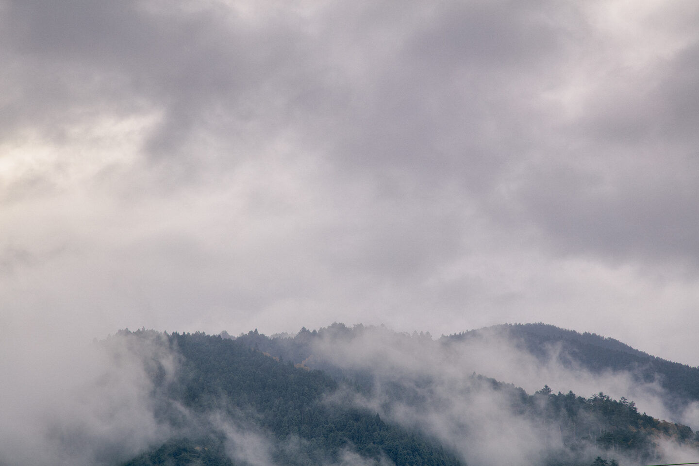 Smoke over a jagged hilltop in Kyoto, Japan as taken by Carol Schiraldi of Carol's Little World. 