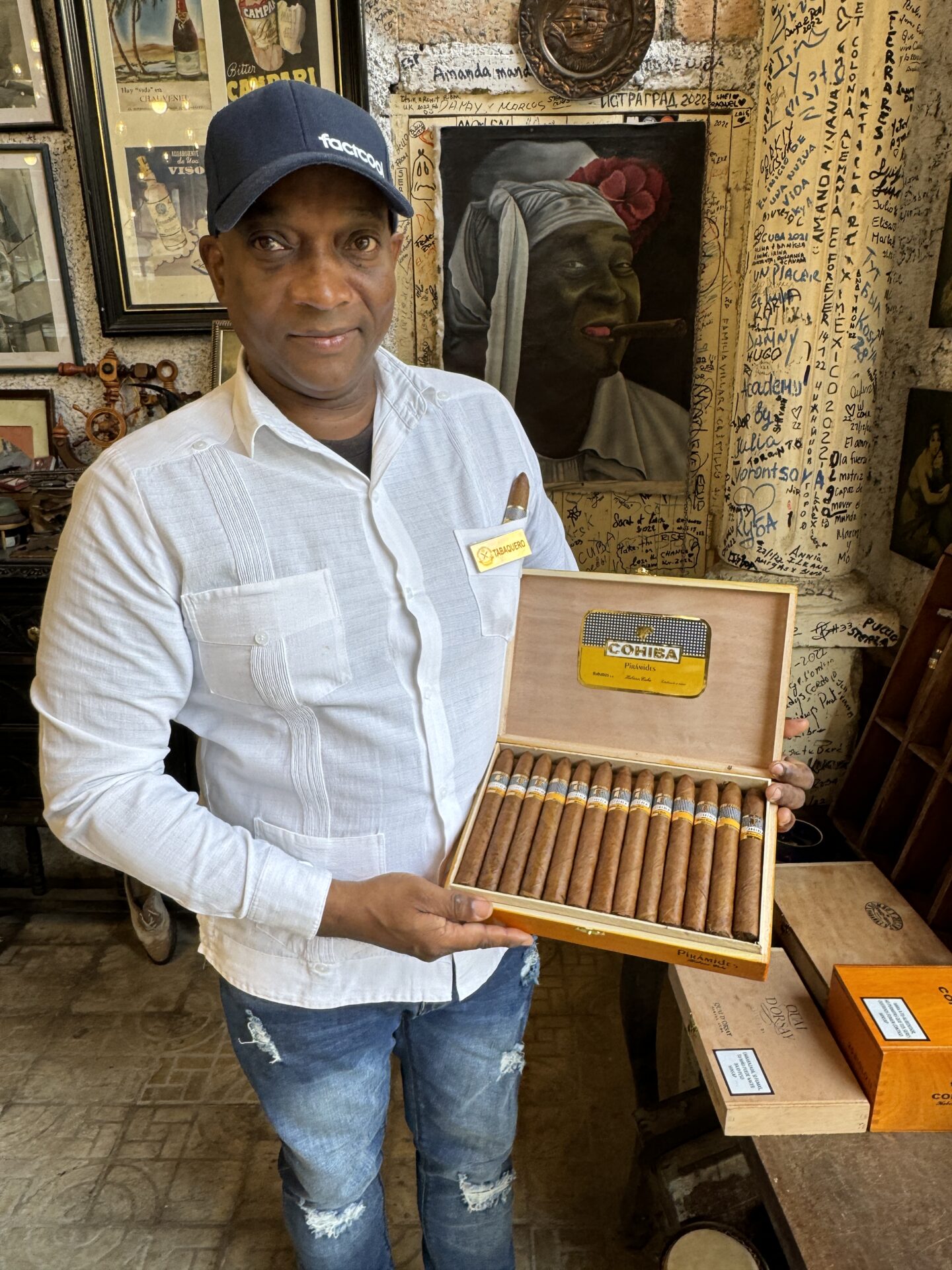 Tobacco expert from the pirate bar in Havana, Cuba, showing a box of Cohibas, as photographed by Carol Schiraldi of Carol's Little World. 