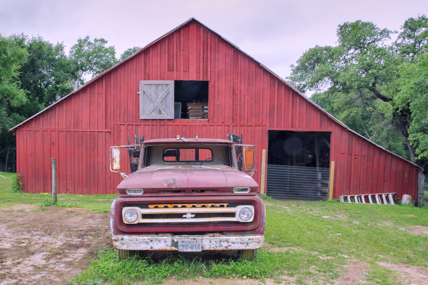 Red truck in front of red barn at Old Settlers Association in Round Rock, Texas. 