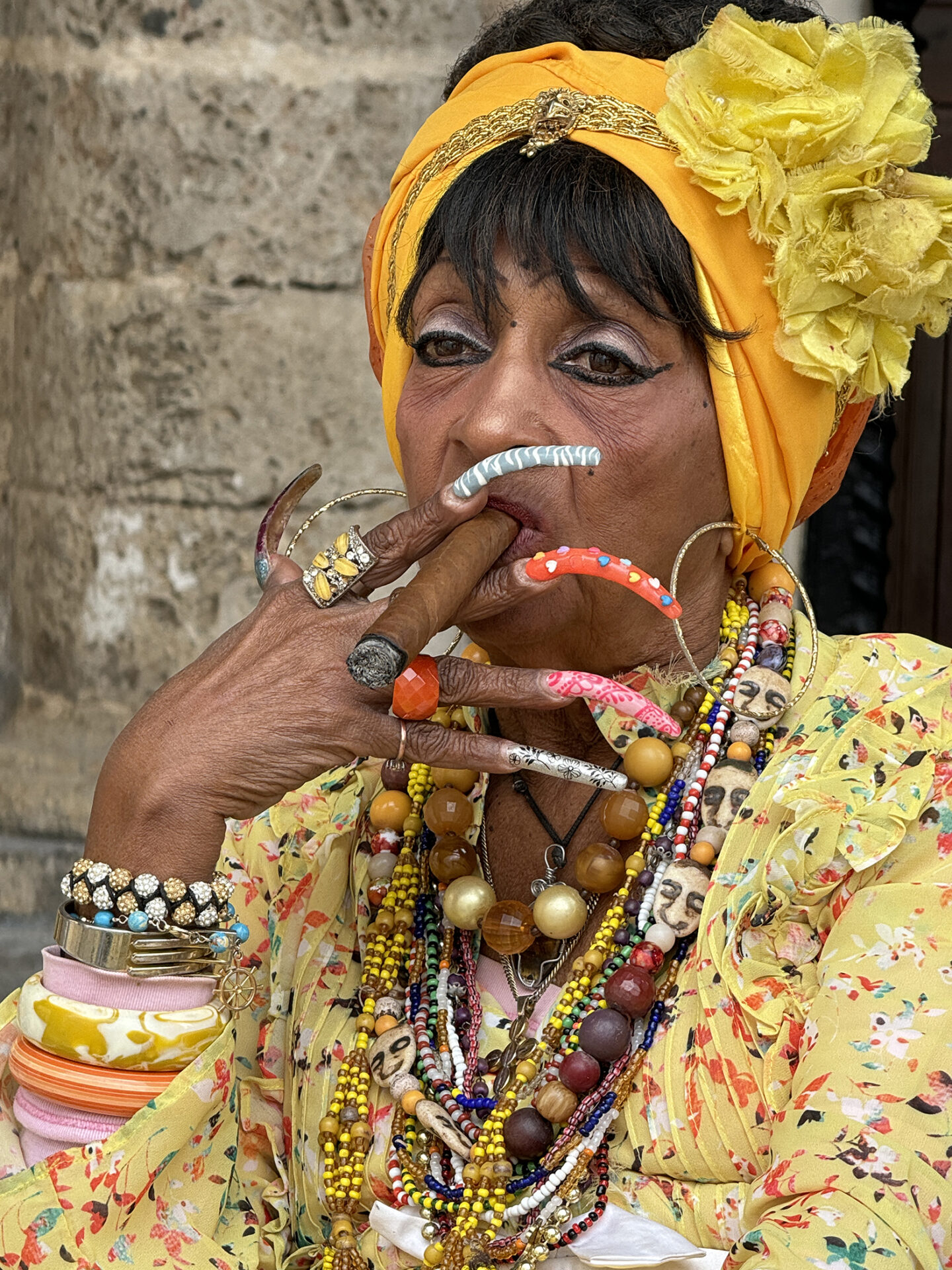 A fortune teller showing us how she reads personalities from the afterlife, with very long nails and colorful clothing. 