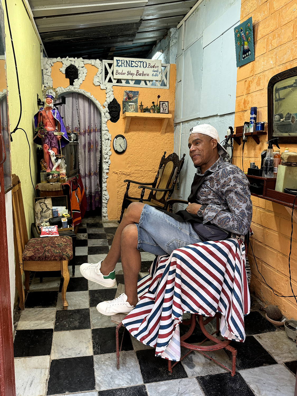 Portrait of a man working in a barbershop in Havana Cuba from the Portraits of Cuba series. 