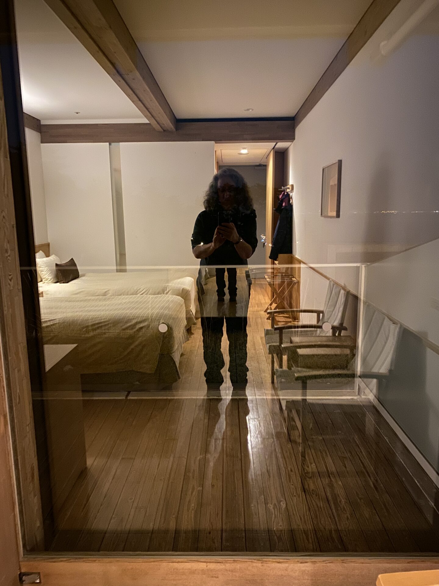 Self portrait of Carol Schiraldi at Benesse House, Japan showing shape of Carol standing in a doorway at night 
