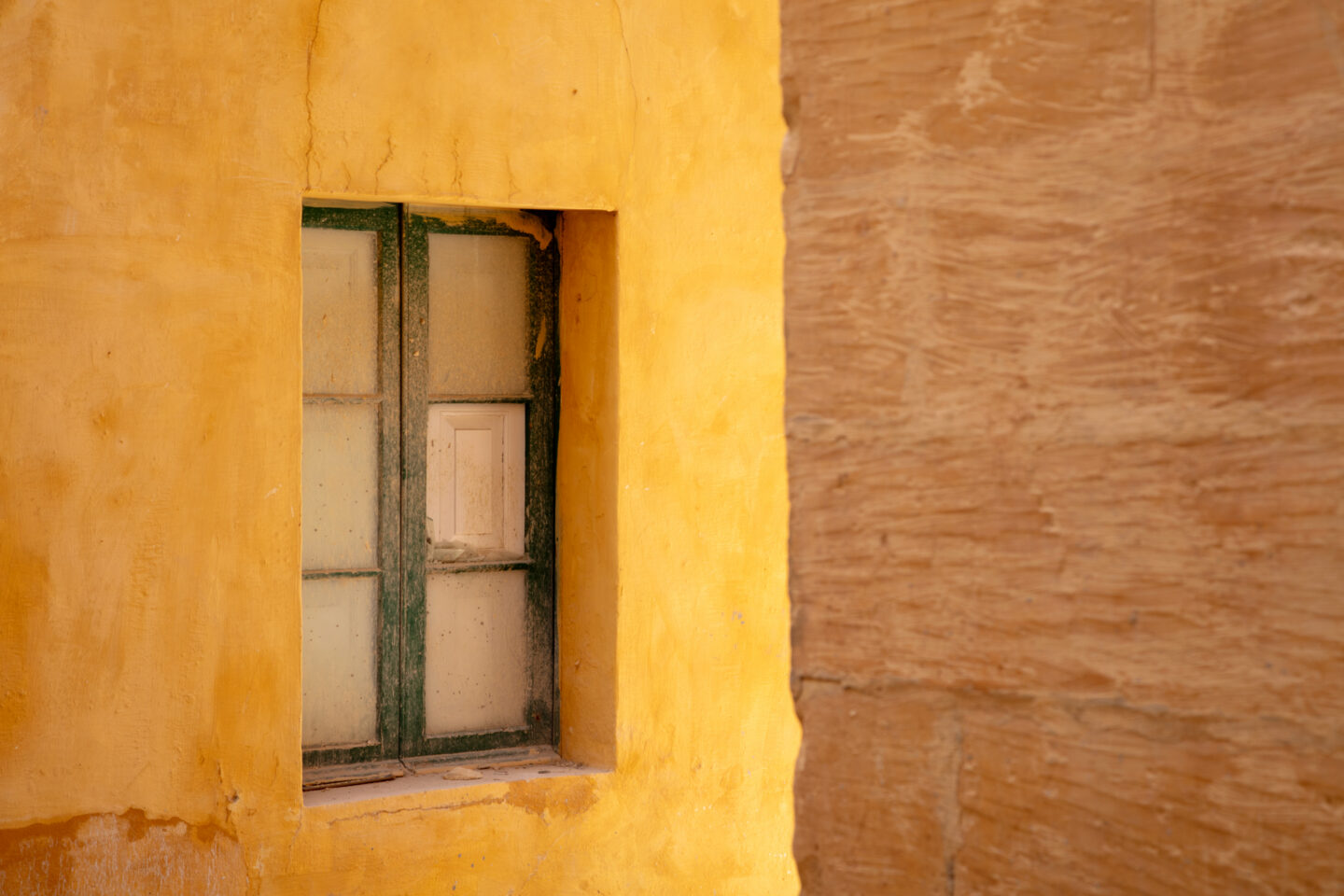 Green window on a yellow limestone wall done for my artist residency Gozo.